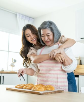 Asian lovely family, young daughter look to old mother cook in kitchen. Asian lovely family, young daughter look to old mother cook in kitchen.