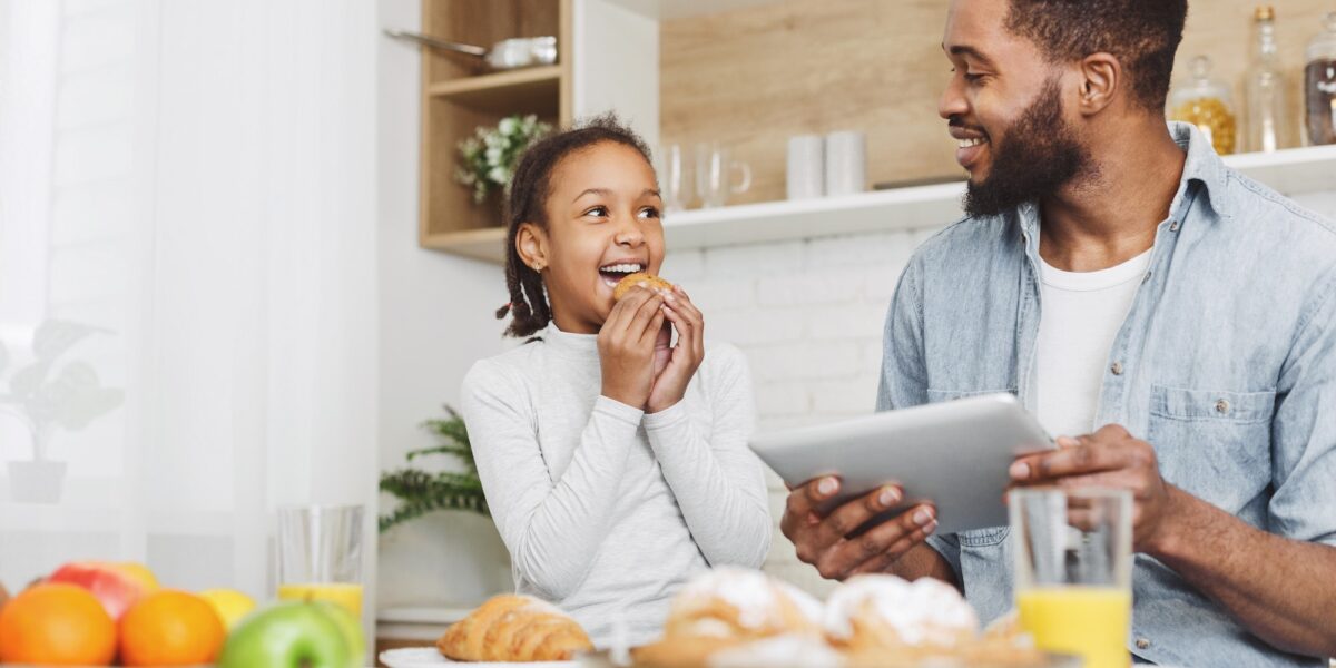 Father and daughter eating sweets and looking for new recipes ( not a patient that uses tooth fillings)