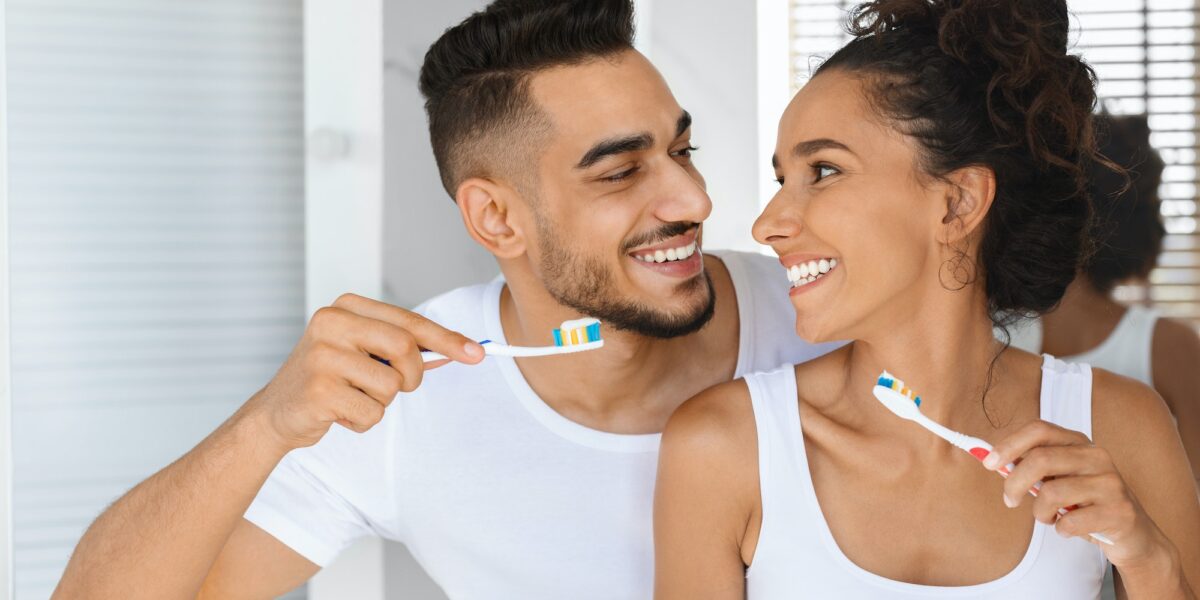 Happy Beautiful Arab Couple Making Morning Hygiene, Brushing Teeth Together In Bathroom TranscenDental Smiles offers professional teeth cleanings