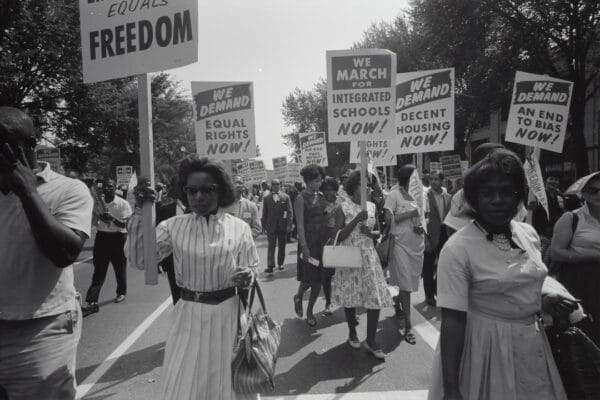 A group of people holding signs in a street.