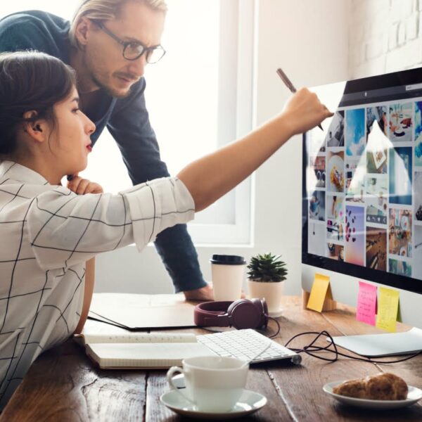 Two people looking at a computer screen.